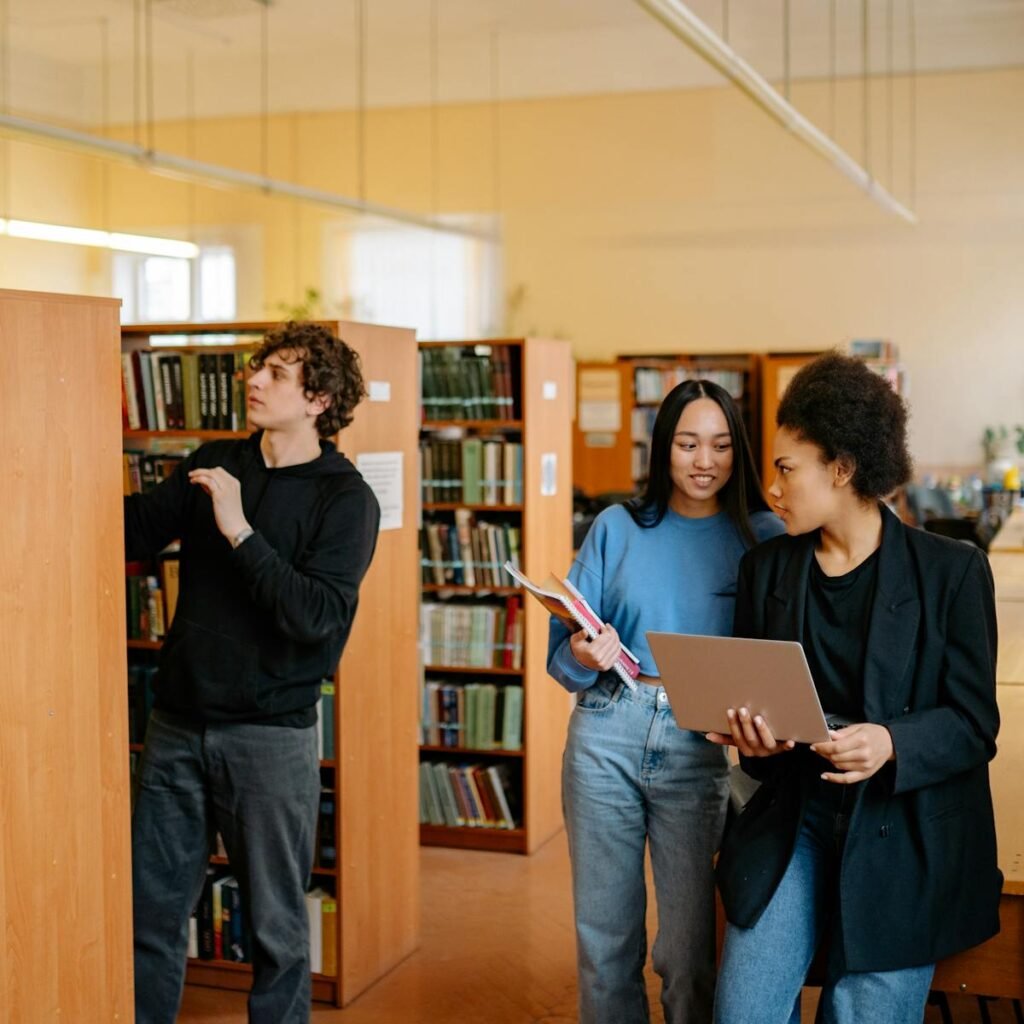 Students collaborate in a university library, engaging in research and study.